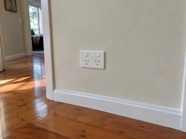 White double power point on a cream hallway wall with timber floor and skirting in Birmingham Gardens
